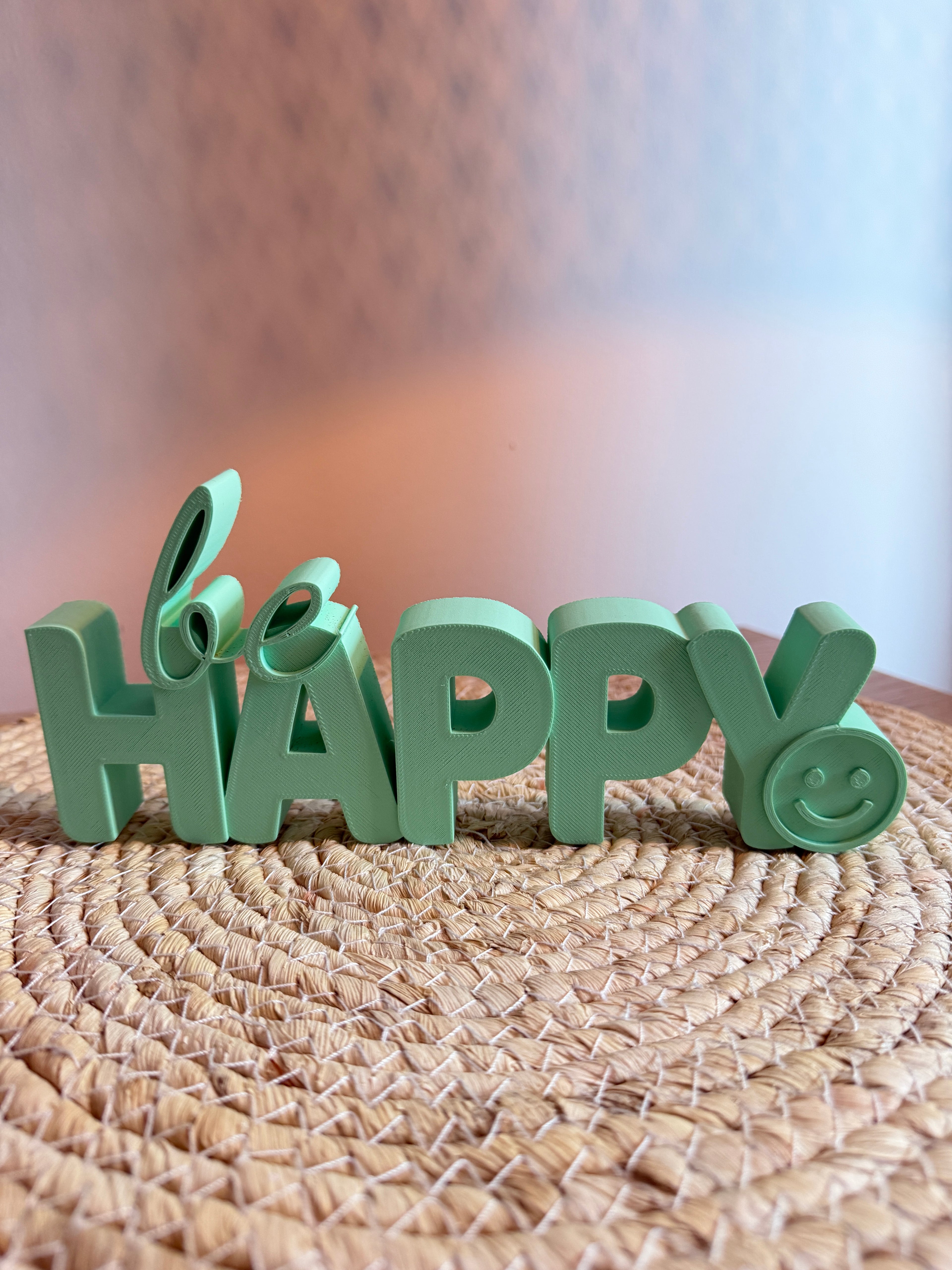 The inscription “be HAPPY😊”